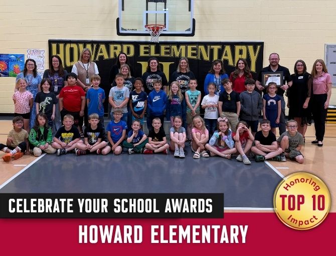Large group of Howard Elementary students and teachers posing in gym