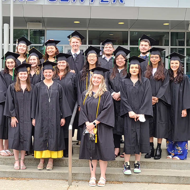 graduates in caps and gowns on steps