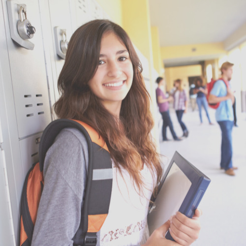 smiling female student holding binder