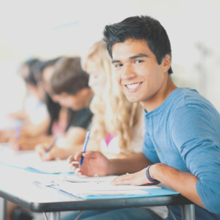 male student smiling in class