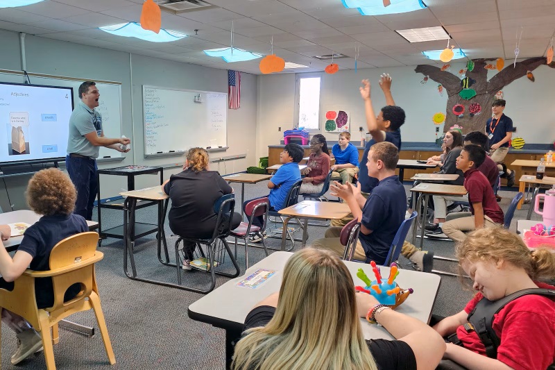 Teacher in front of room full of students