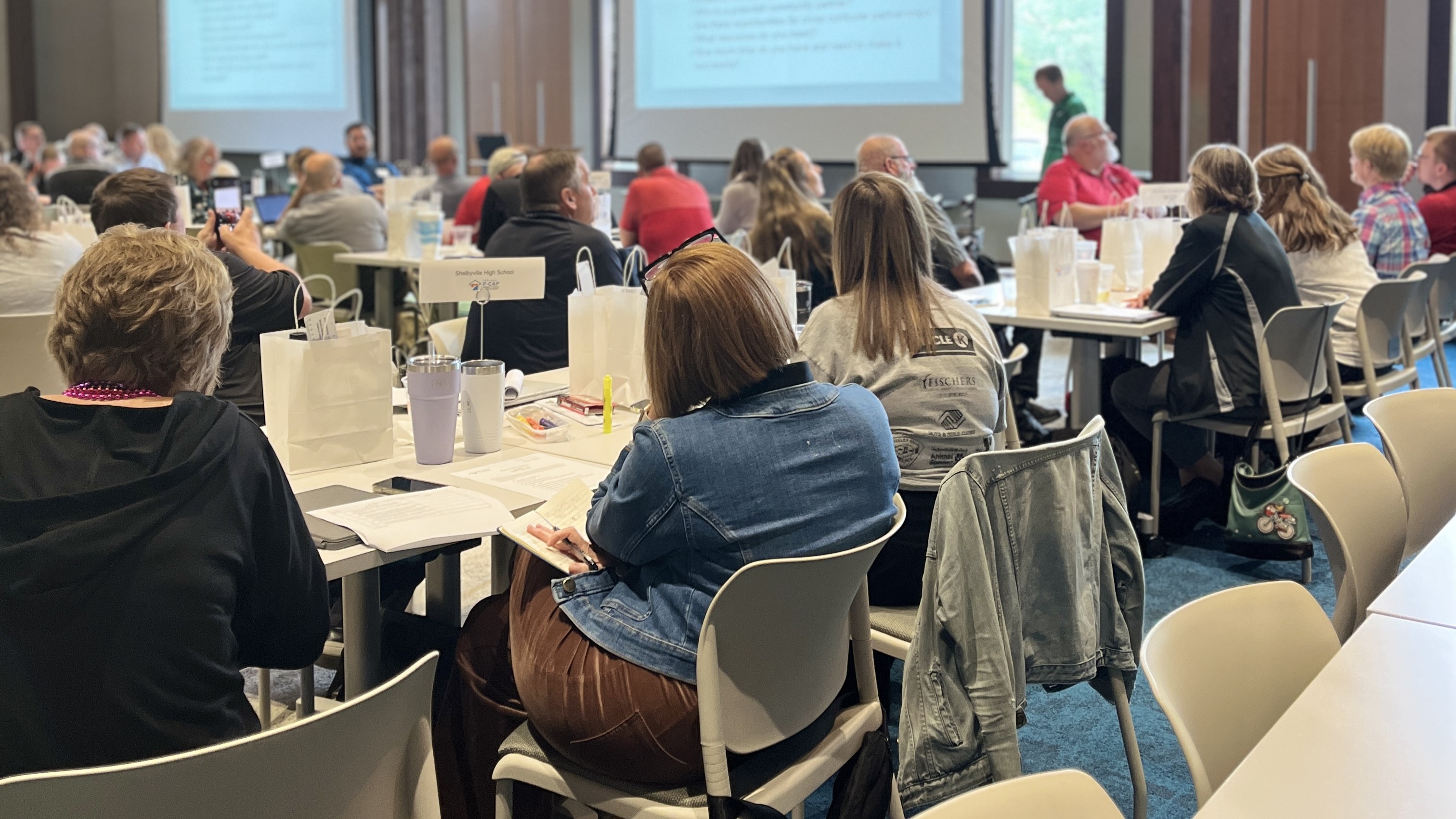 adults in a large meeting room