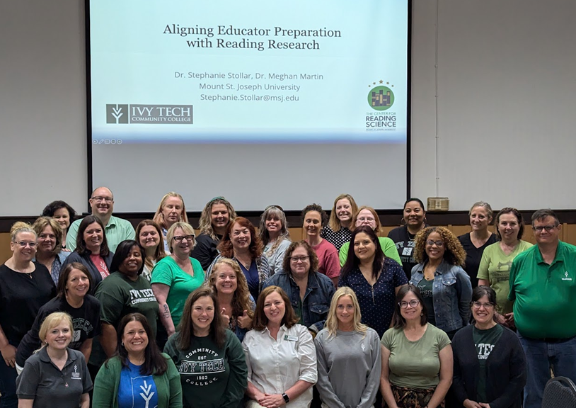 Group photo with slide "Aligning Educator Preparation with Reading Research"