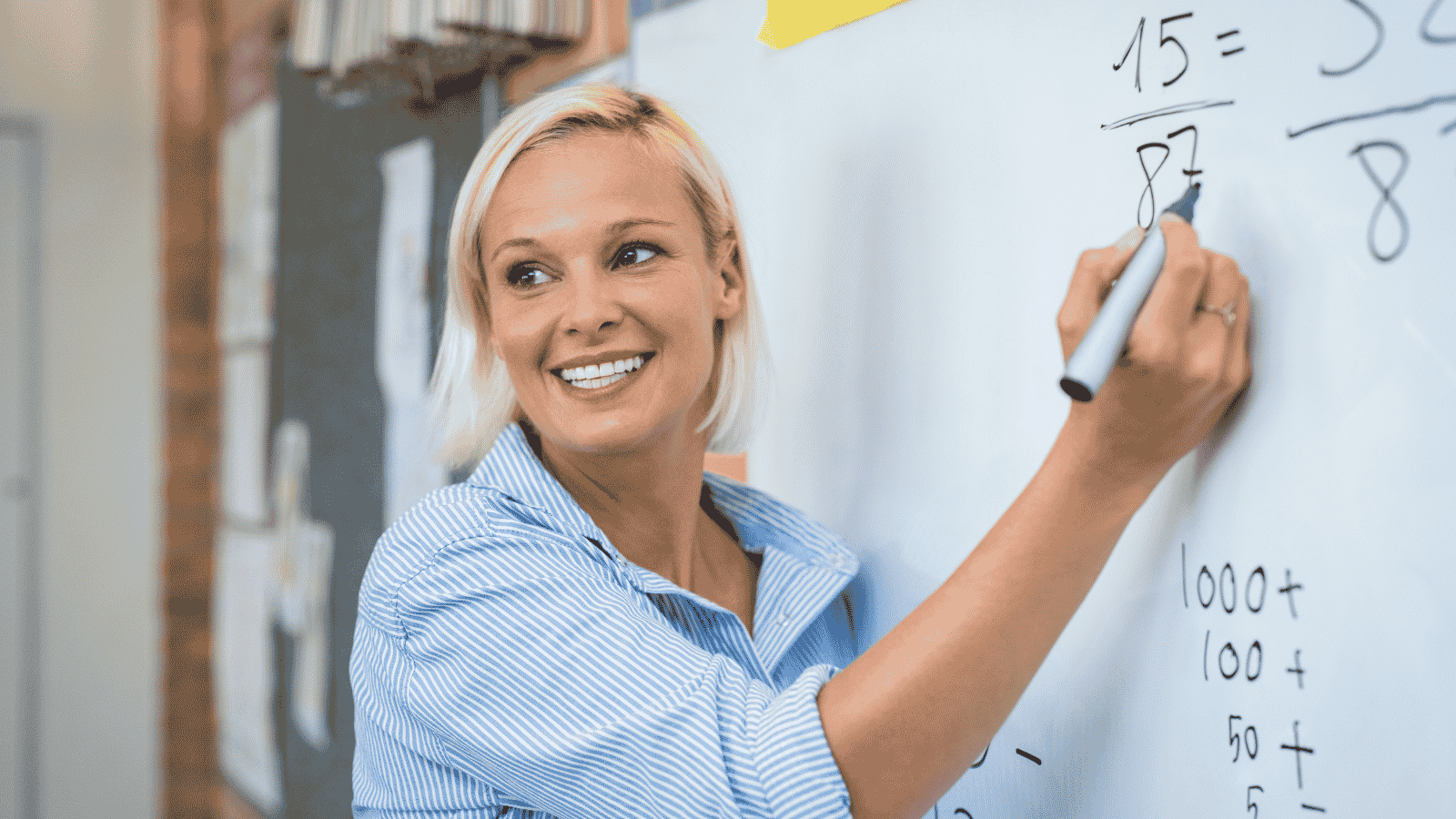 Teacher holding marker at whiteboard