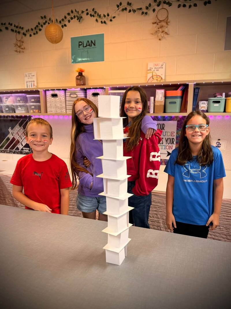 Students display their tower made of notecards