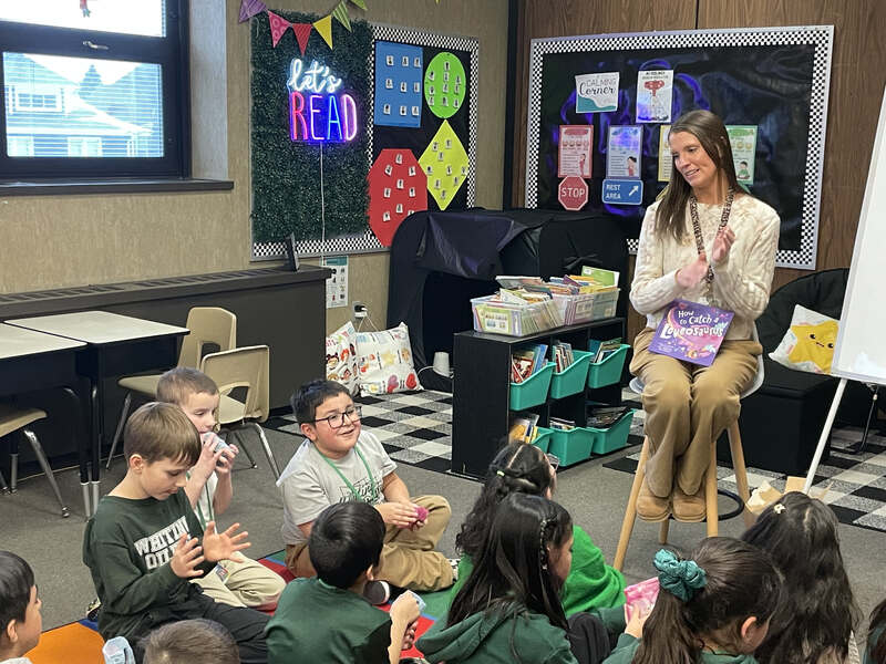 Second grade teacher Stephanie Cook reads to students